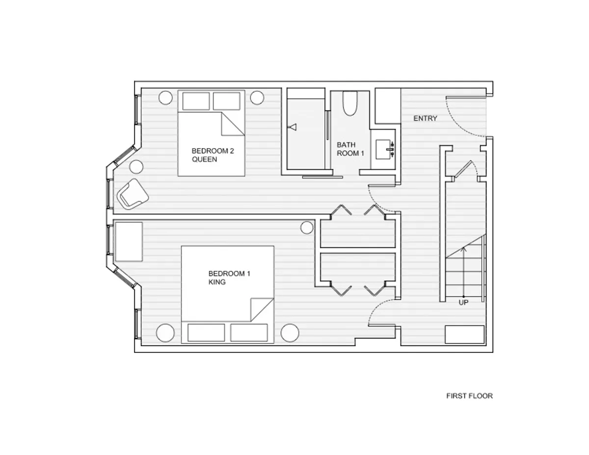 A wide view of the condo’s interior, including the entryway, two bedrooms, bathroom, and cozy living area. The space looks inviting for socializing, relaxing after a day out, or gathering with friends and family, with plush furniture and ambient lighting.